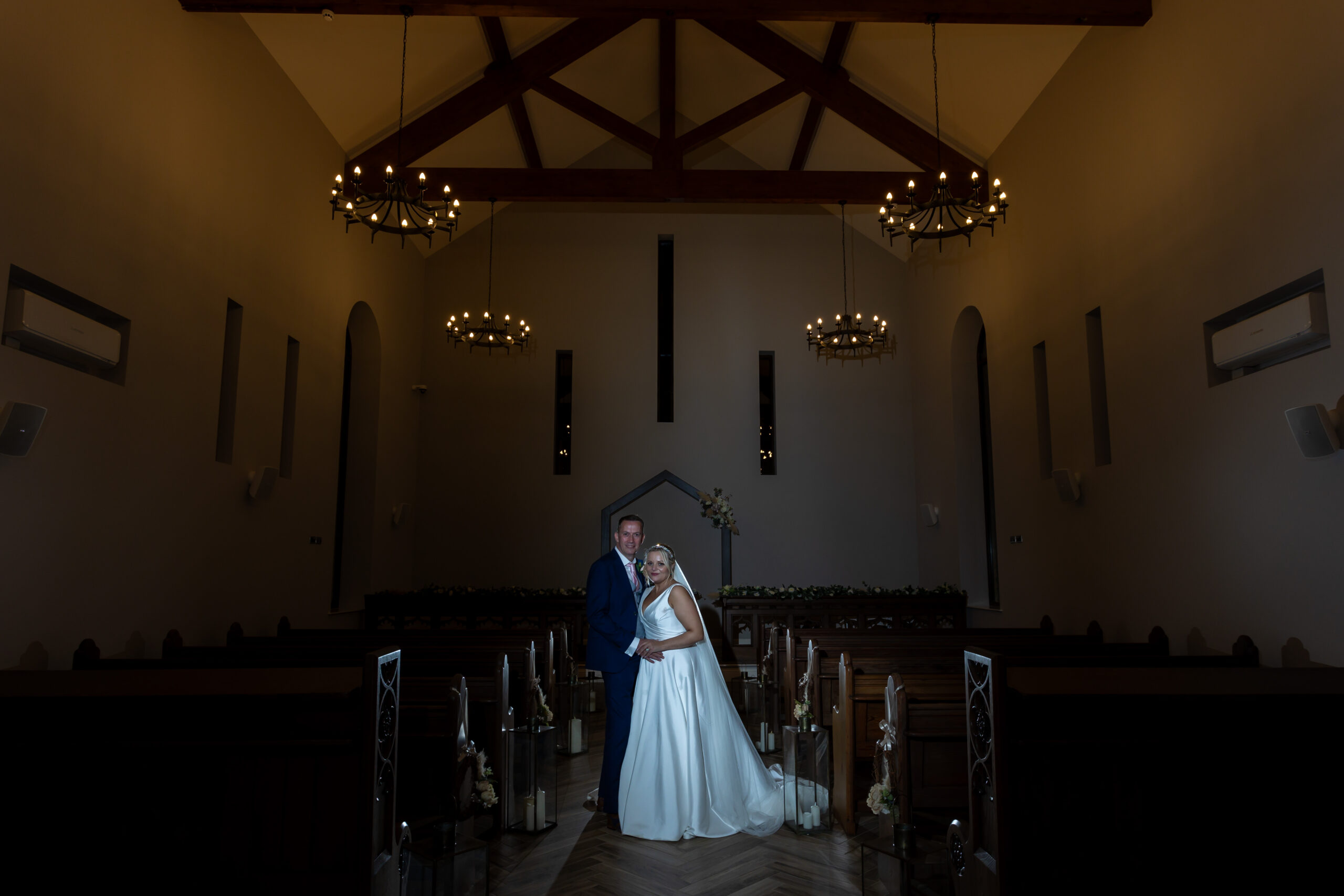 Bride and groom in candlelit church interior